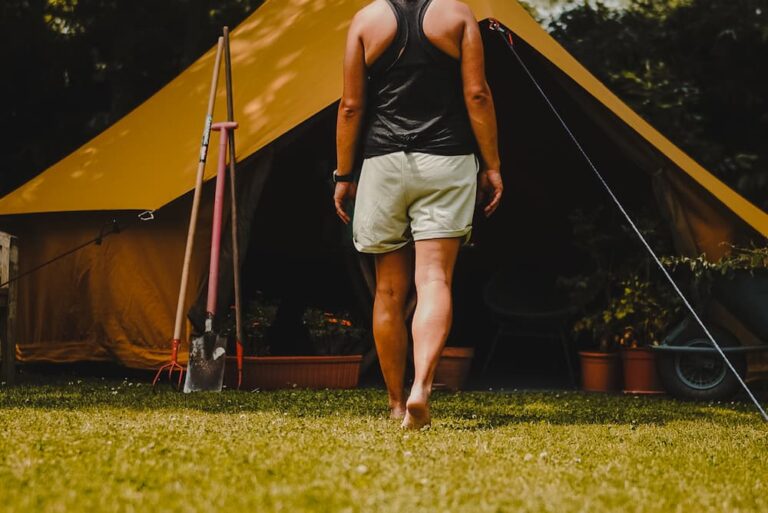 Autentic | Luxury Glamping Bell Tents - Woman walking in front of the Autentic yellow 5m bell tent