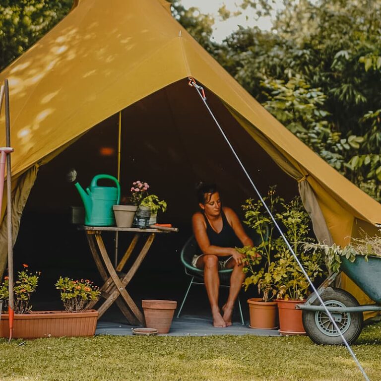 Autentic | Luxury Glamping Bell Tents - Woman gardening inside the yellow Autentic 5m bell tent