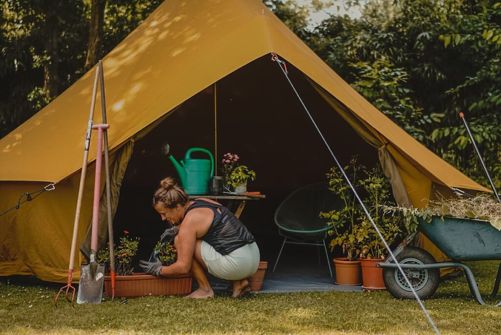Autentic | Luxury Glamping Bell Tents - Woman gardening in front of the Turmeric Major 5m glamping bell tent