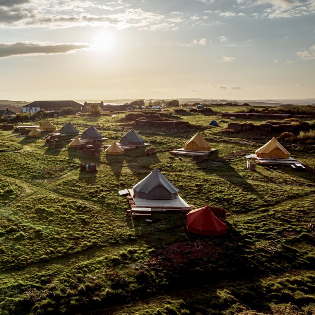 Autentic | Luxury Glamping Bell Tents - Multiple colourful cotton canvas glamping tents of the Autentic brand at the Sea Forts glamping site in Cornwall