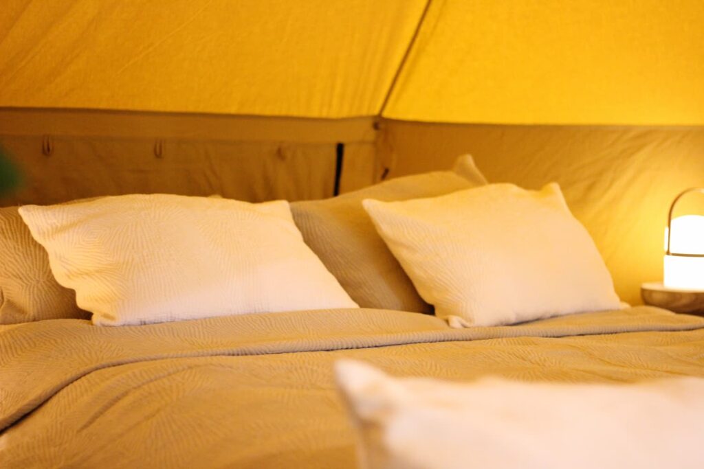 Autentic | Luxury Glamping Bell Tents - Toison d'Or bed linen in an Autentic Turmeric 5m bell tent