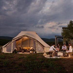 Autentic | Luxury Glamping Bell Tents - Dinner with friends in front of the Autentic Desert Billy-Joe Double Bell Tent during a summer night