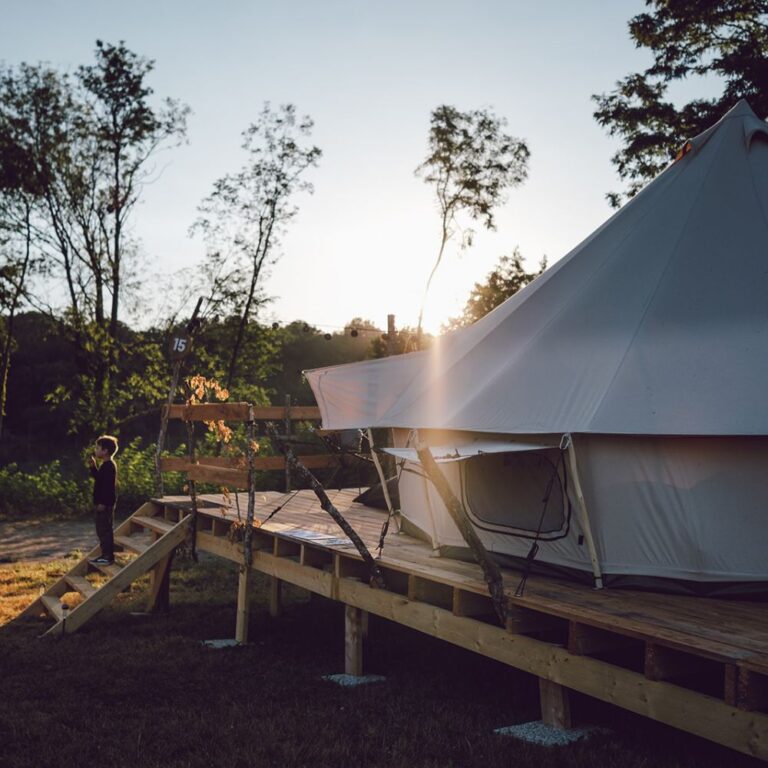 Autentic | Luxury Glamping Bell Tents - Child standing in front of a Desert 5m Jack Bell Tent at the Chateau Planckaert glamping site
