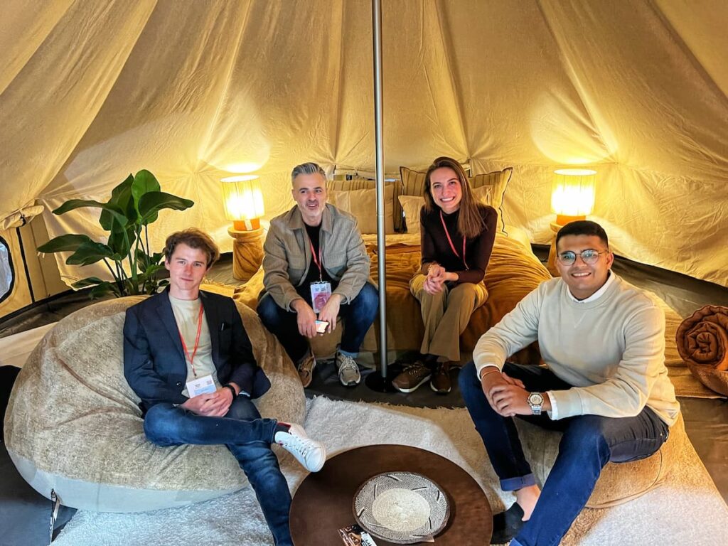 Autentic | Luxury Glamping Bell Tents - The Autentic team sitting in the furnished 5m Jack Bell Tent set up at the Maison&Objet fair in Paris
