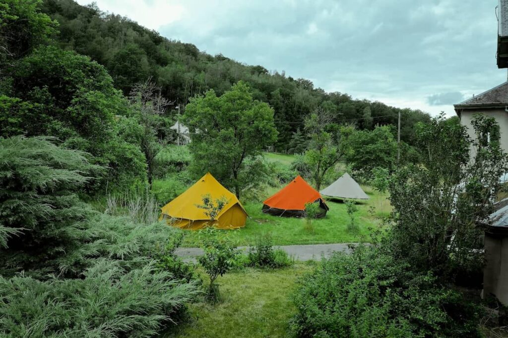 Autentic | Luxury Glamping Bell Tents - Colourful 5m canvas bell tents set up by Forest To Plate in a grass field