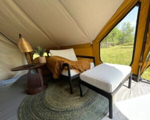 Autentic | Luxury Glamping Bell Tents - An Ethnicraft seat and Danye rug used in the Autentic Billy-Joe Double Bell Tent during Antwerp Design Week
