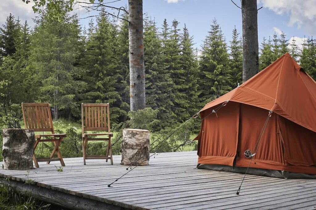 Autentic | Luxury Glamping Bell Tents - Roasted Pumpkin 3m glamping bell tent on a wooden platform at the Camp Kartano glamping site in Finland