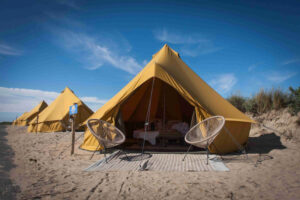 Autentic | Luxury Glamping Bell Tents - Multiple yellow 5m glamping bell tents at the Deluxe Beachcamp glamping site of Organic-Concept and Connections