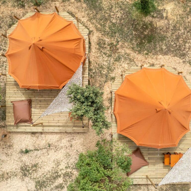 Autentic | Luxury Glamping Bell Tents - Drone view of 2 Red Sand Jack Bell Tents at Camp Faro in Portugal